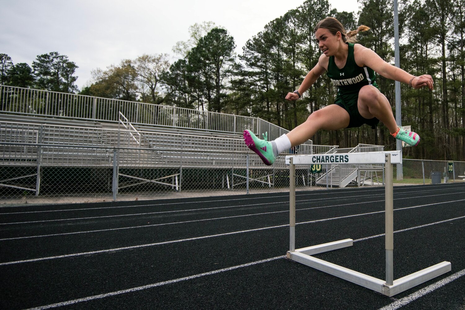 Northwood athlete Julia Hall clears a hurdle during the girls 300-meter race at the Chatham County track and field championships.